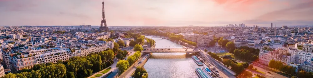 Paris aerial panorama with river Seine and Eiffel tower, France. Romantic summer holidays vacation destination. Panoramic view above historical Parisian buildings and landmarks with sunset sky
